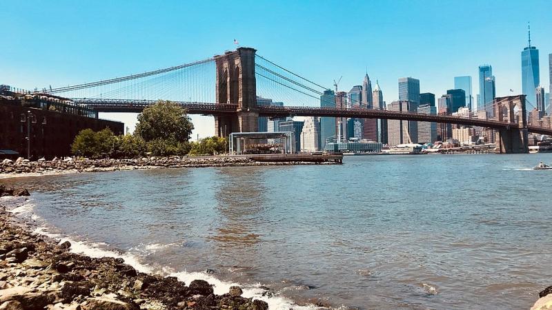 A photo of the Brooklyn Bridge with the New York City skyline A view of the Brooklyn Bridge with the Manhattan skyline in the background
