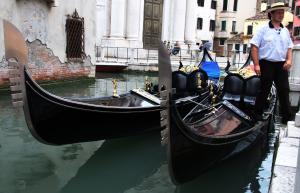 A classic black gondola floating on a Venice canal
