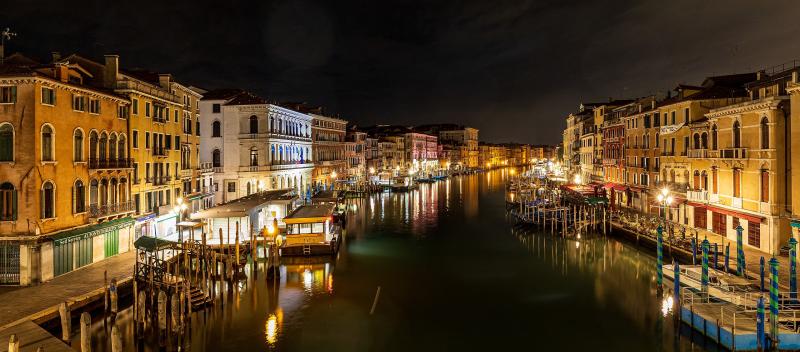 The Grand Canal of Venice at night with lights reflecting