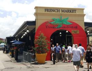 A bustling outdoor market with food vendors and souvenirs