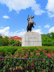 A statue of Andrew Jackson on a horse in the center of Jackson Square