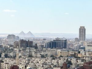 The iconic pyramids of Giza are visible in the distance from a vantage point at the Cairo Citadel.
