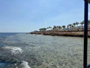 The turquoise water of the Red Sea and a sandy beach in Sharm El Sheikh.