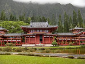 The vibrant red Byodo-In Temple surrounded by lush green mountains